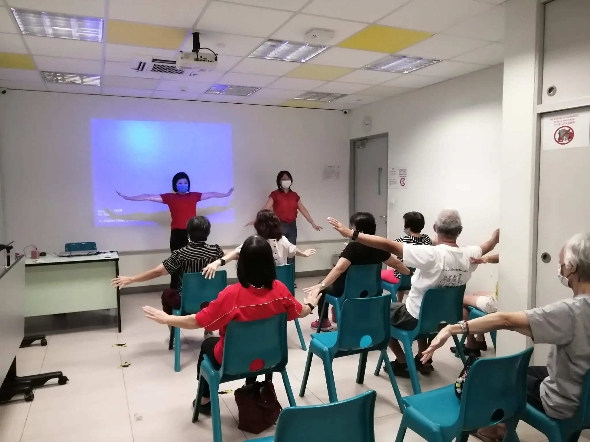 Faith Ong, Fang Feng, and Angela Wong assisting seniors during the session