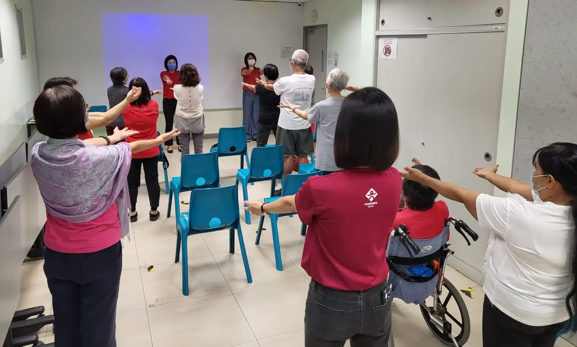 Group photo of SWA Laughter Yoga team and CDAC Tampines seniors