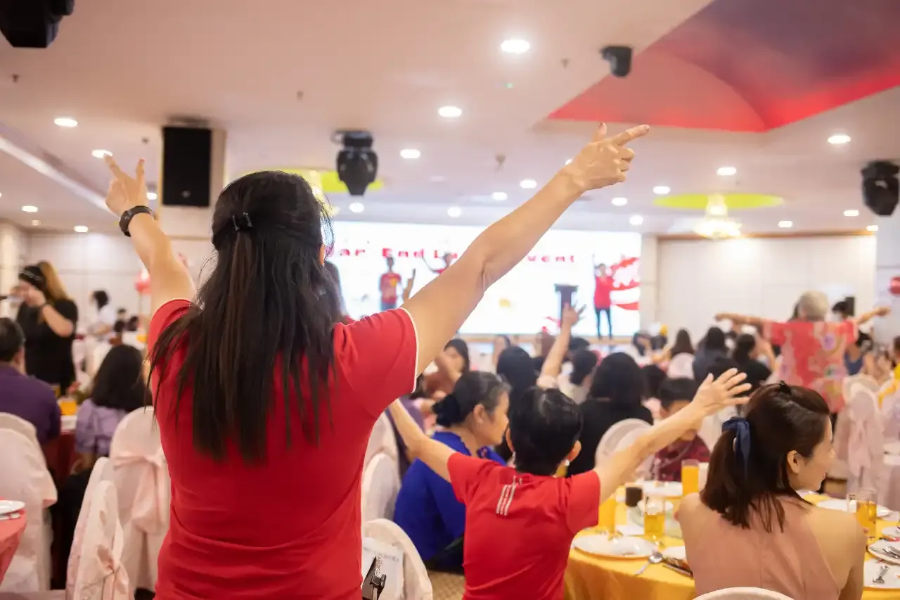 Residents laughing and connecting during the Laughter Yoga warm-up session