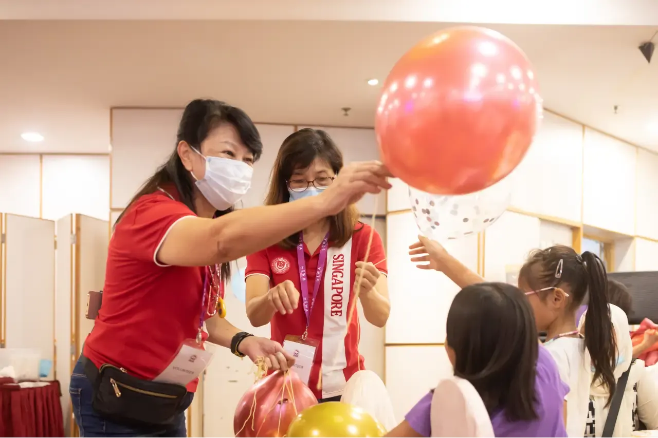Children playing with balloons distributed by SWA volunteers
