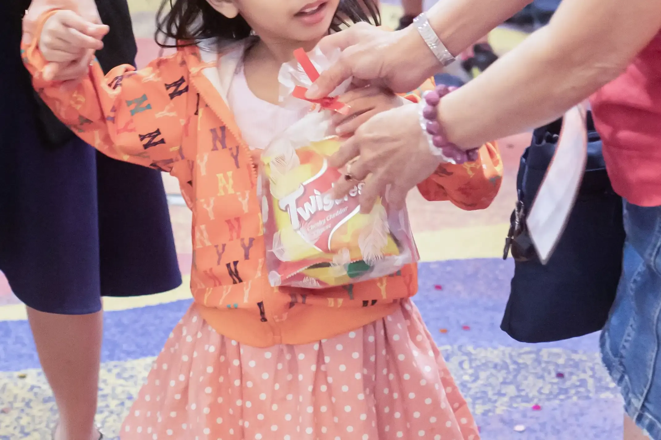 Children receiving goodie bags of chocolates and candies at the end of the event