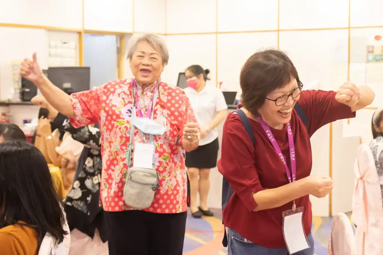 Angela Wong and Feng Fang guiding residents through Laughter Yoga exercises