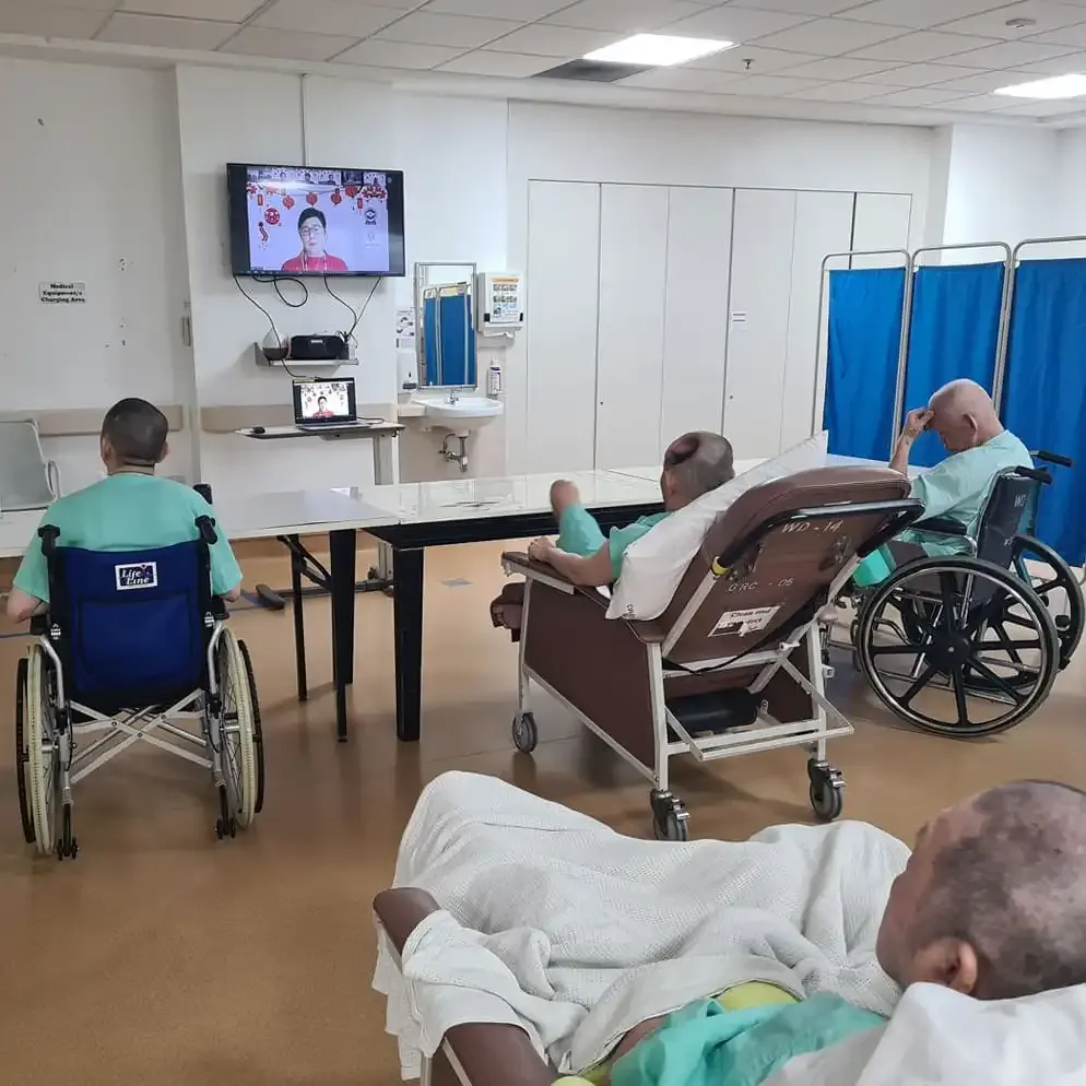 Residents waving and enjoying the sing-along session during the virtual celebration
