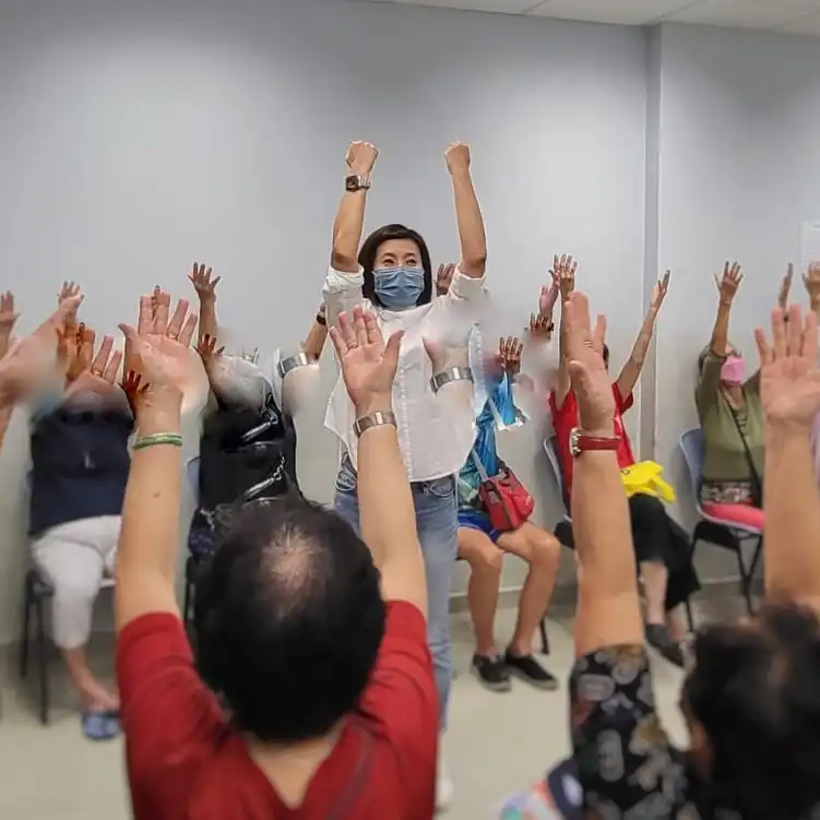 Seniors doing Laughter Yoga exercises at CDAC Yishun Centre