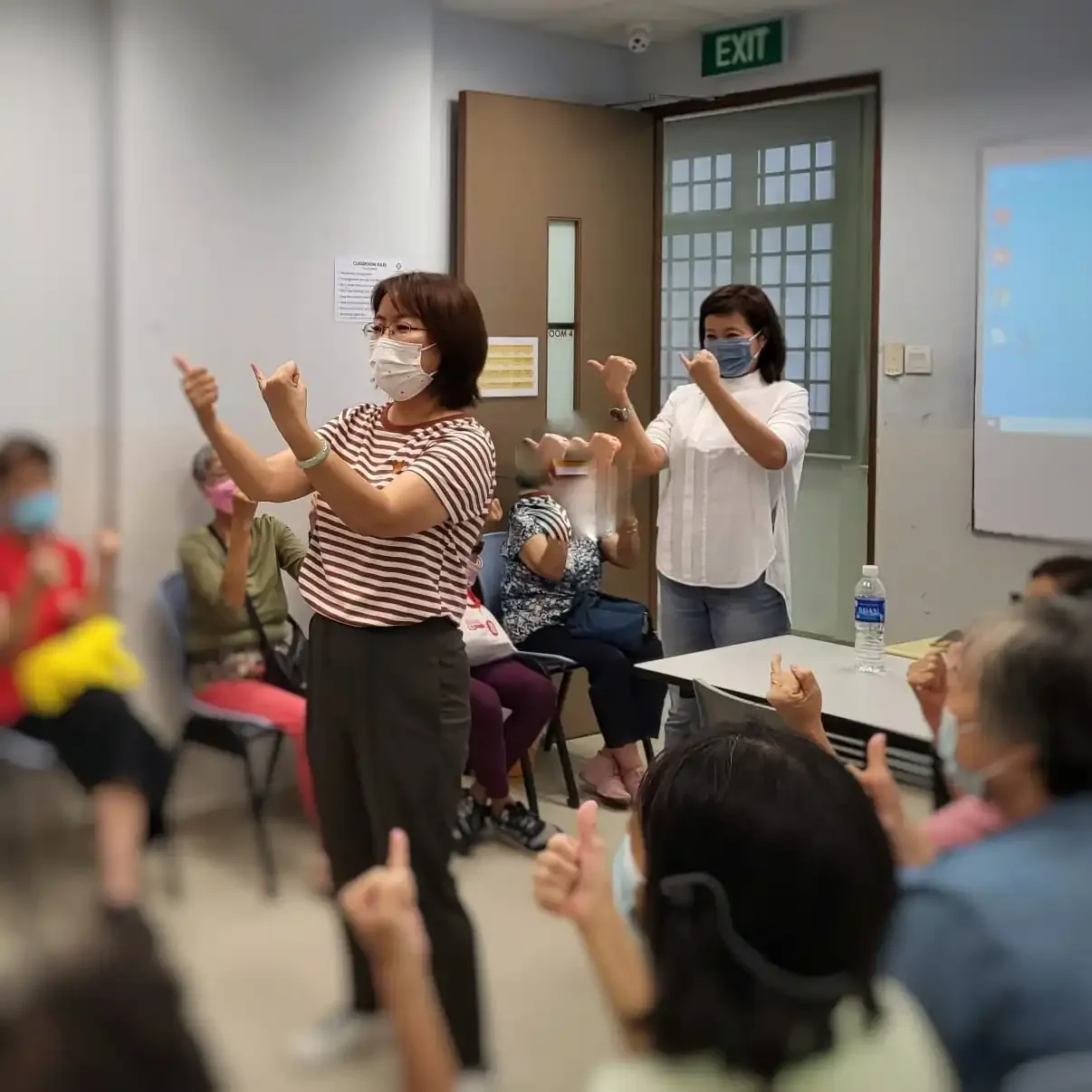 SWA Laughter Yoga team posing with CDAC Yishun Centre seniors after the session