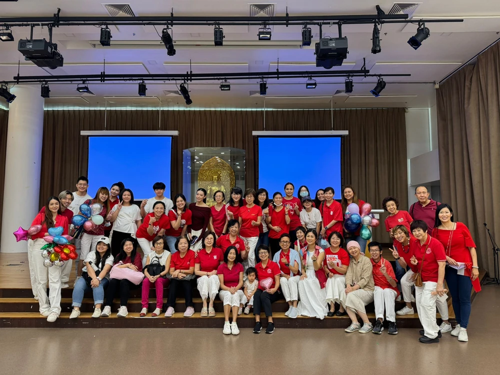 Group photo of volunteers and residents at the National Day celebration