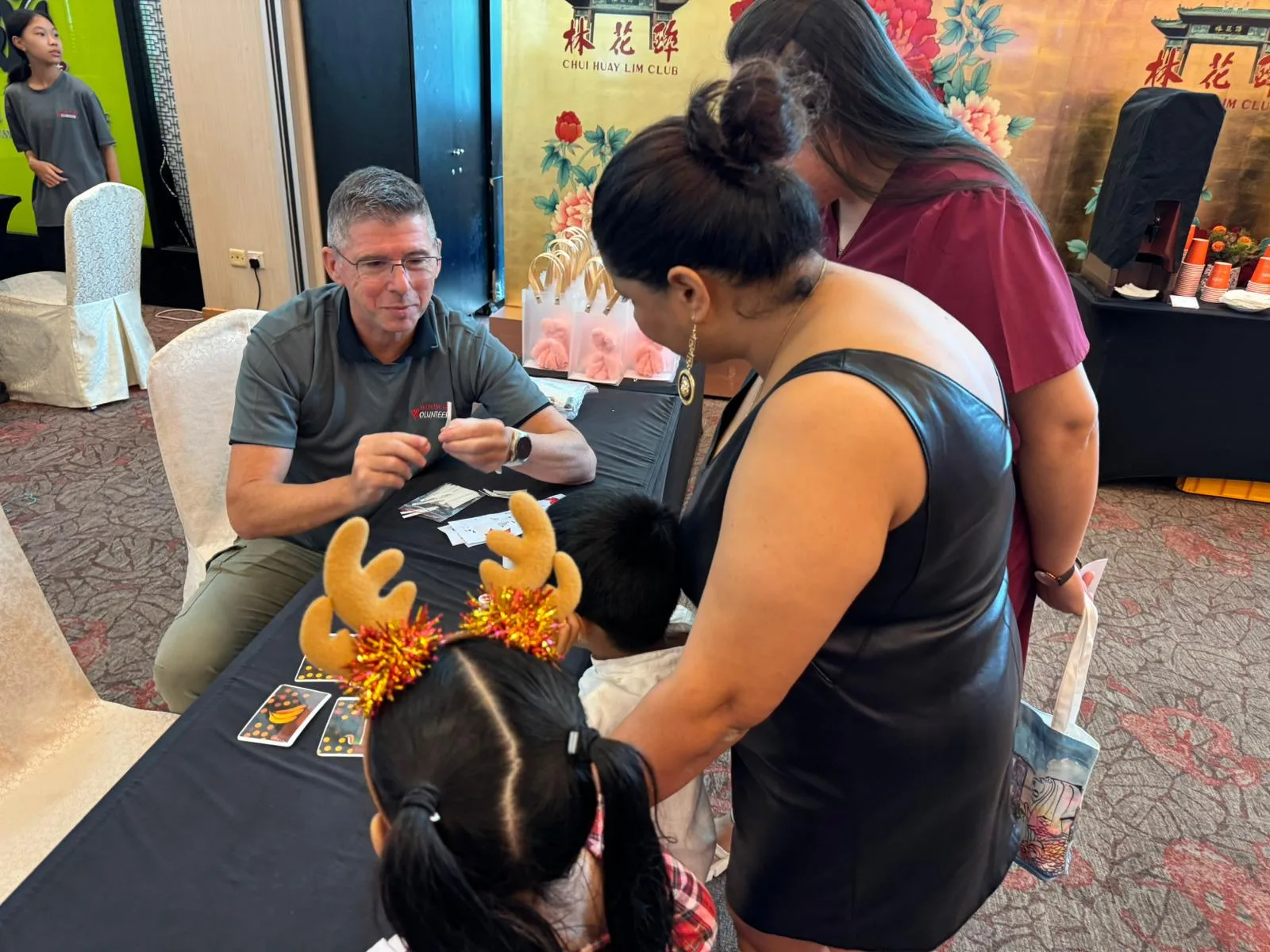 Families participating in game booth challenges