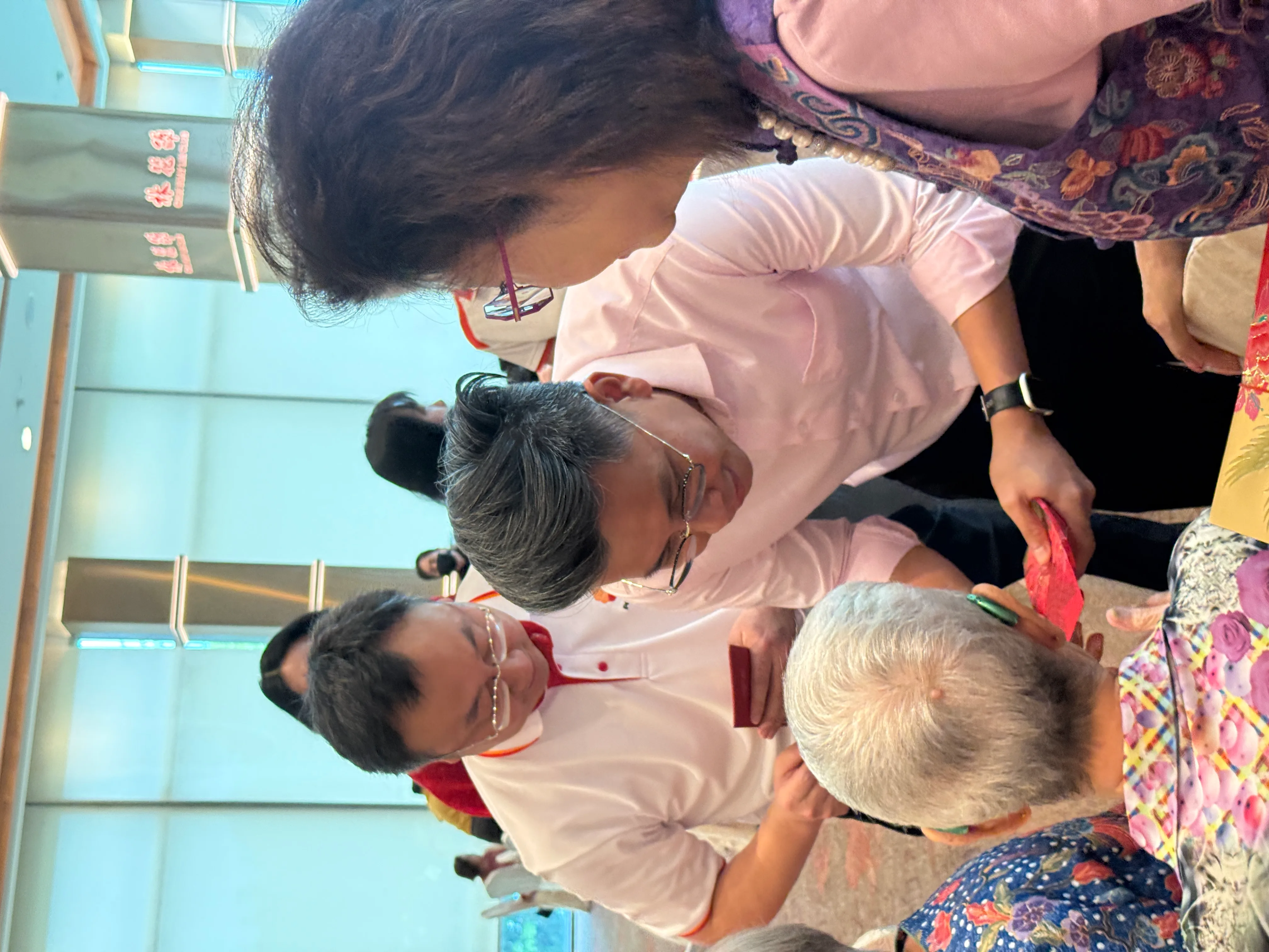 Mr Ng Shi Xuan presenting ang bao to a senior
