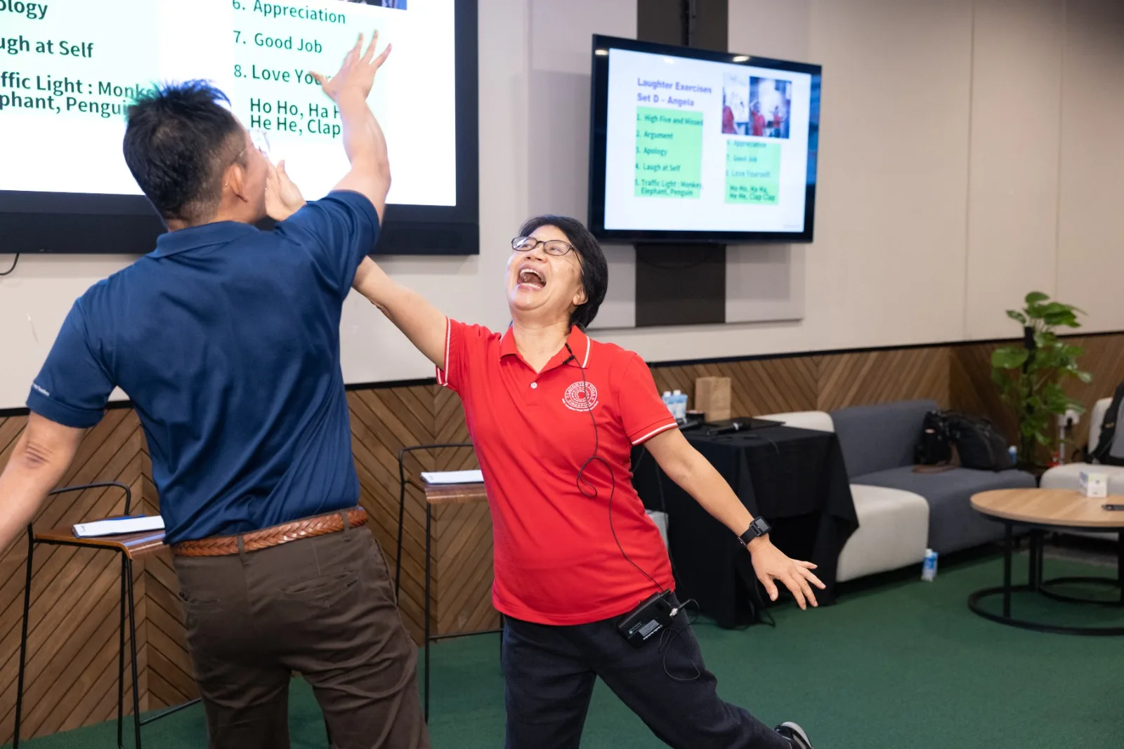 SMU alumni participating in Laughter Yoga exercises led by SWA